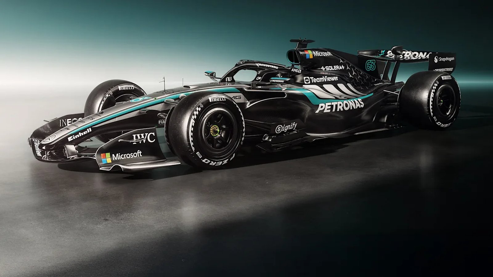 The Mercedes-AMG F1 W17 E Performance in George Russell's number 63 livery, shot from a front three-quarter angle in a studio, black bodywork with a silver spine and Petronas teal accents. | Russell's W17, the car that has taken the other four.